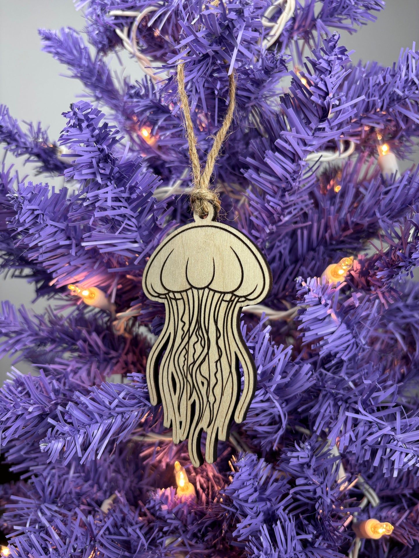 Decorative jellyfish ornament on a purple Christmas tree.