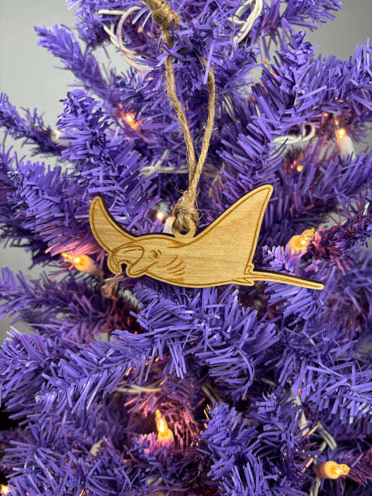Wooden Manta Ray ornament on a purple Christmas tree with lights.
