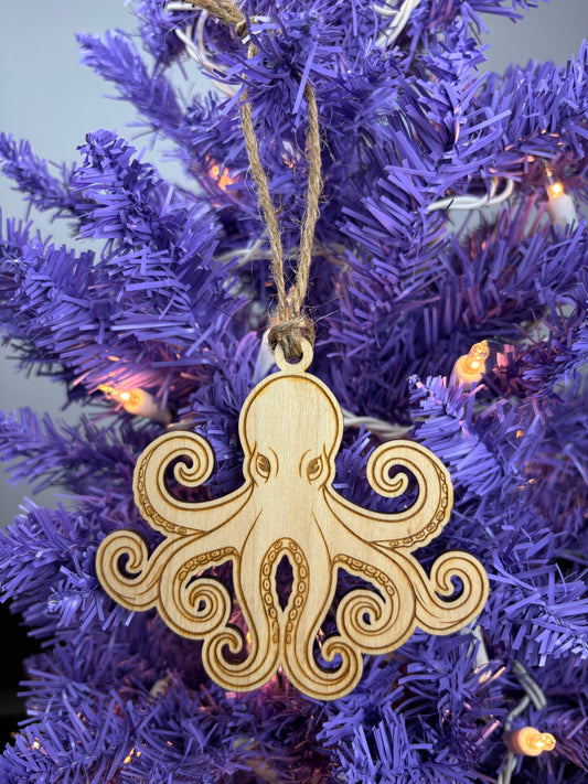 Decorative wooden octopus ornament on a purple Christmas tree.
